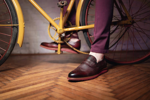 istock Unrecognizable man in elegant shoe, near bicycle 1356983772