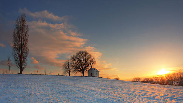 istock Beautiful winter landscape at sunset with chapel and snow 135698402