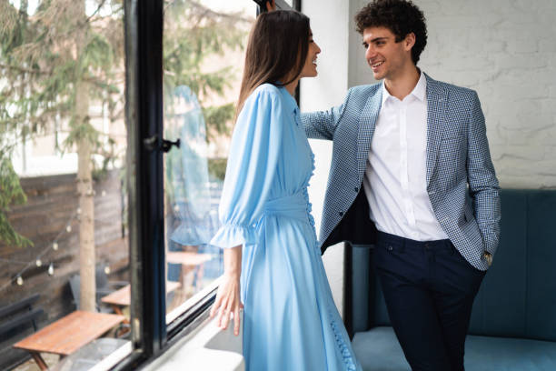 istock Modern young man flirting with a beautiful woman 1356984793