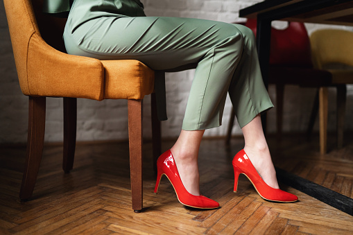 Unrecognizable woman wear red high heels