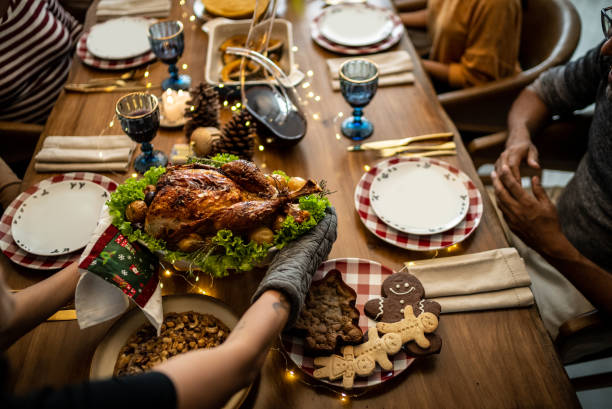 istock Hands serving a roast turkey on Christmas at home 1356986653