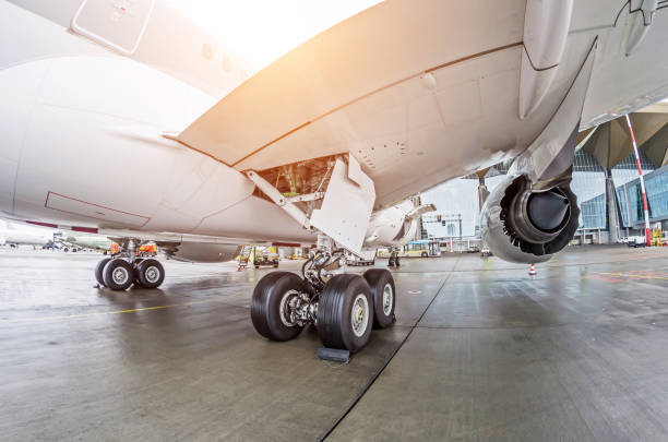 istock Wheels rubber tire rear landing gear racks, under wing engine rear back view. 1356987702