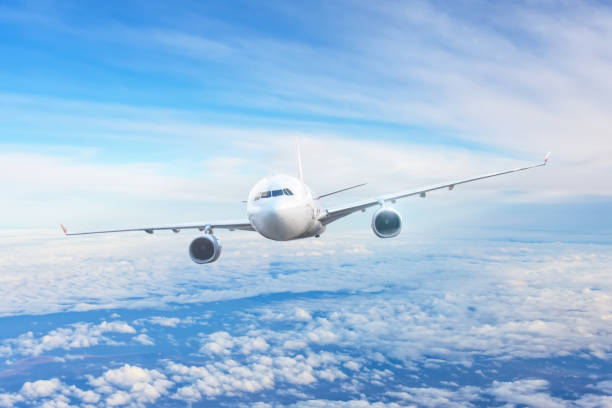 istock Passenger airliner flight in the blue sky among the clouds. 1356987751