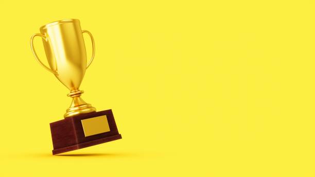 istock 3D Rendering Golden Award Trophy Cup isolated on yellow background 1356988989