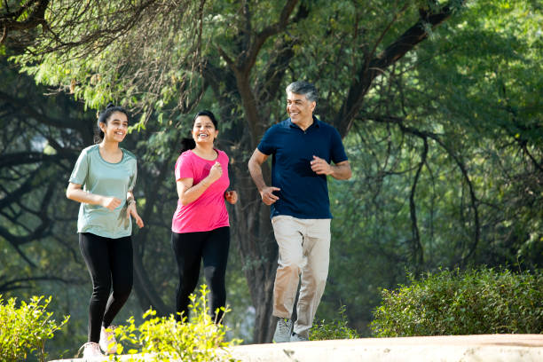 istock Happy family jogging at park 1356990188