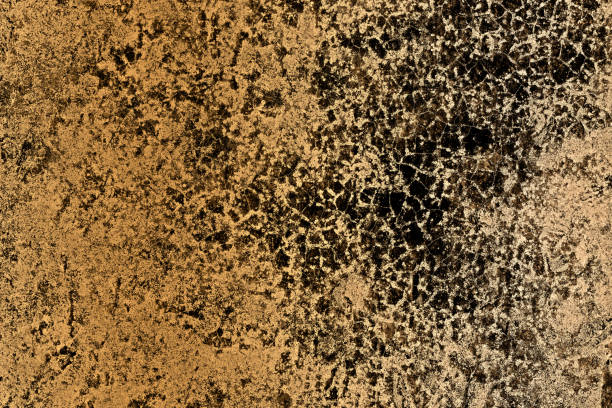 istock Heavy black grunge texture on a yellow concrete floor surface 1356993490