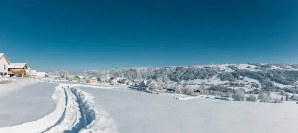 Snowy village of Scheffau in the Allgäu on a sunny winter day