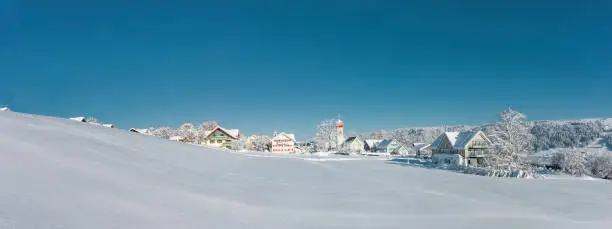 Snowy village of Scheffau in the Allgäu on a sunny winter day