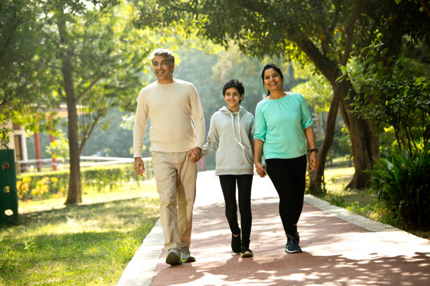 istock Happy family walking at park 1356997114