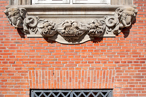 Decorative window cill moulding and brickwork, Copenhagen, Denmark. Copenhagen, Denmark’s capital, lies on the coastal islands of Zealand and Amager. Indre By, the city's historic centre, contains Nyhaven and Frederiksstaden, with the royal family’s Amalienborg Palace. Also, Christiansborg Palace and the Renaissance Rosenborg Castle, which is surrounded by gardens, is home to the crown jewels