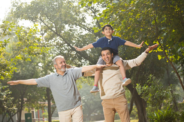 istock Three generation family having fun at park 1356998013