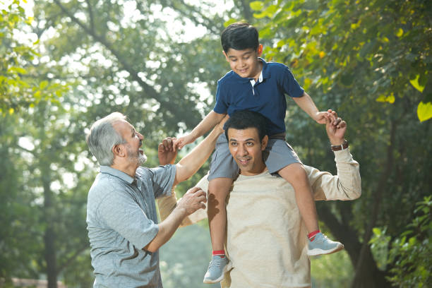 istock Three generation family having fun at park 1356998075