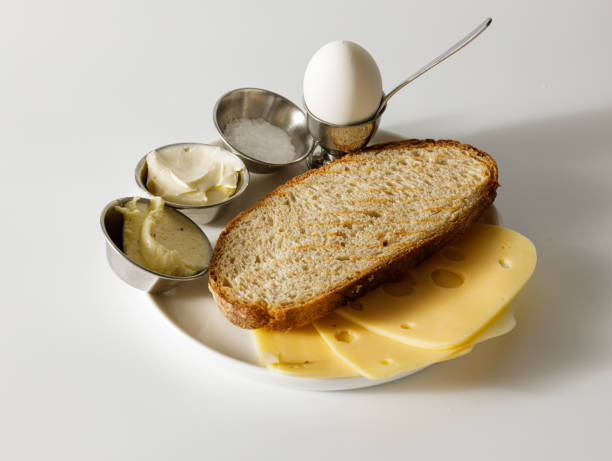Snacks for lunch on white plate on the table Healthy foods for breakfast. Sous, salt and hard boiled egg in bowl. Sandwich with cheese granary toast stock pictures, royalty-free photos & images