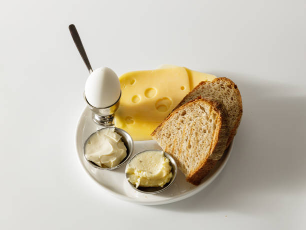 Top view of meals for breakfast on white plate Healthy food for eating. Sous, salt and hard boiled egg in bowl. Bread with cheese granary toast stock pictures, royalty-free photos & images