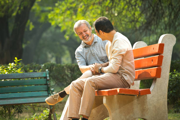 istock Old man spending leisure time with son at park 1356998415