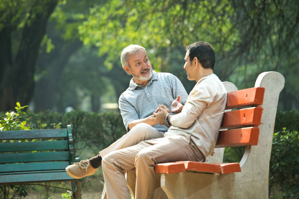 istock Old man spending leisure time with son at park 1356998432