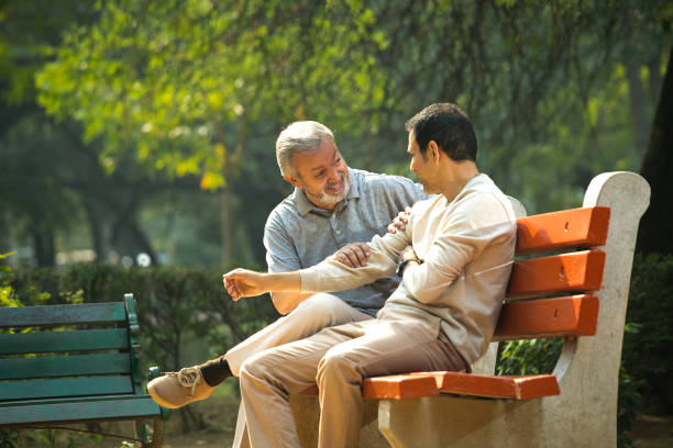 istock Old man spending leisure time with son at park 1356998450