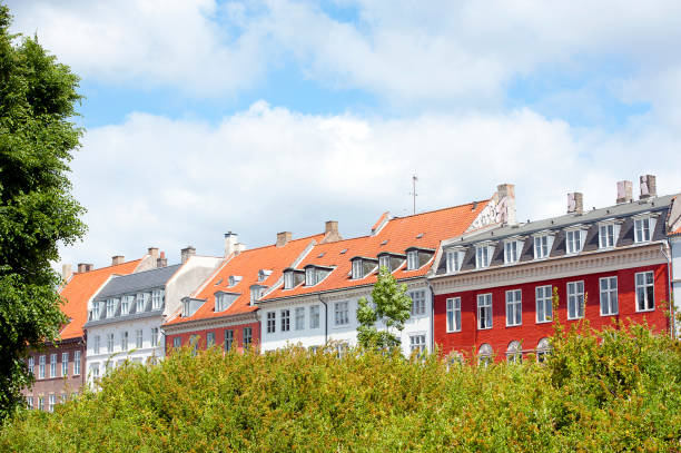 Terrace rooftops, Nyhavn, Copenhagen, Denmark. Copenhagen, Denmark’s capital, lies on the coastal islands of Zealand and Amager. Indre By, the city's historic centre, contains Nyhaven and Frederiksstaden, with the royal family’s Amalienborg Palace. Also, Christiansborg Palace and the Renaissance Rosenborg Castle, which is surrounded by gardens, is home to the crown jewels
