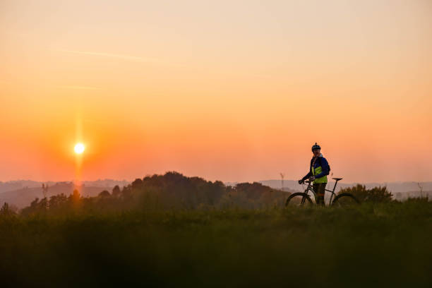 istock Cyclist resting while riding a mountain bike in the nature 1356999035