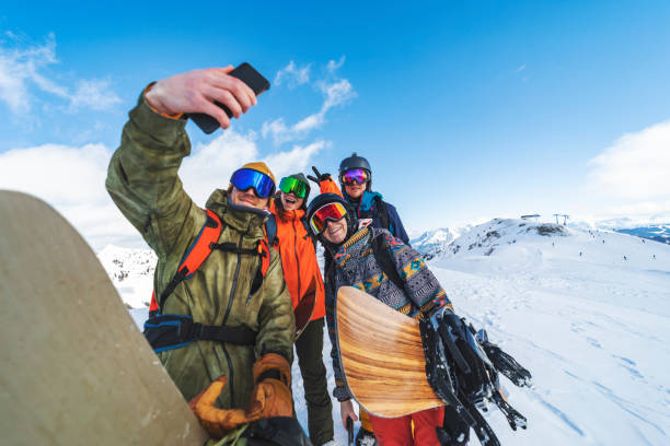 istock Group of snowboarders making selfie in mountains 1356999085