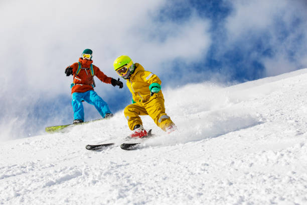 father and son skiing in mountains - family skiing ski vacations imagens e fotografias de stock