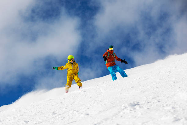 istock Father and son skiing in mountains 1356999169