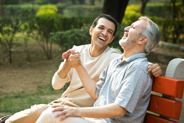istock Old man spending leisure time with son at park 1356999581