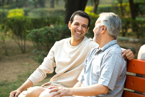 istock Old man spending leisure time with son at park 1356999612