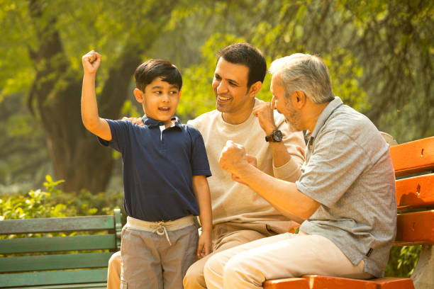 istock Three generation family celebrating success at park 1357000536