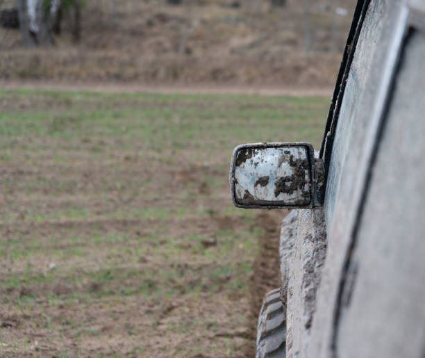 istock Muddy car mirror on off road steppe adventure trail 1357001670