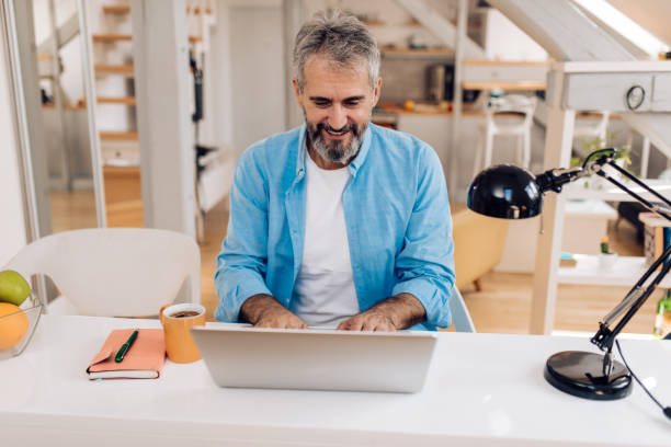 istock Mature businessman working online from home 1357001750