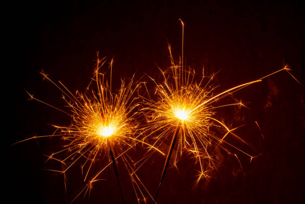istock Bright burning sparklers on the dark background 1357002778