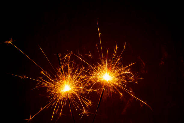 istock Bright burning sparklers on the dark background 1357002818
