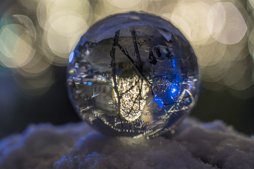 Illuminated Presern trg at night reflecting in crystal ball,  Christmass decorations