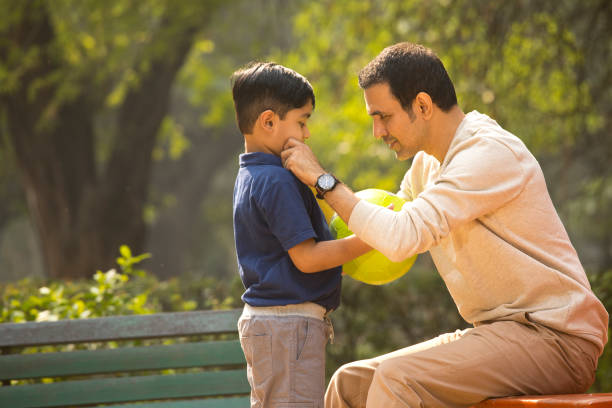 istock Carefree father and son having fun at park 1357004060