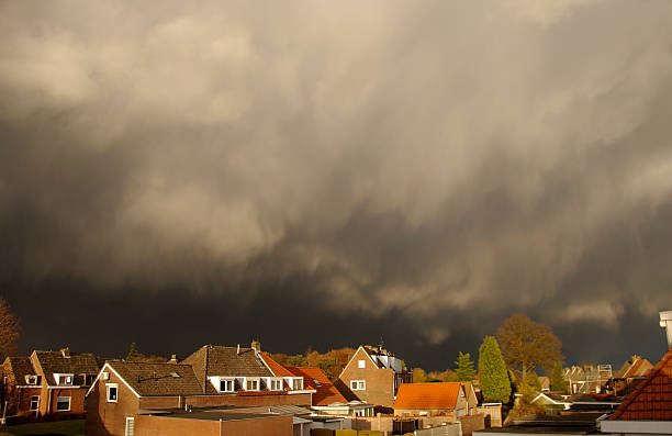 istock Serious dark storm clouds approach a nice neighborhood 135700504