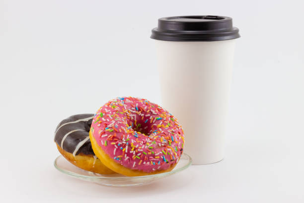 istock colorful donuts and paper coffee cup 1357007568