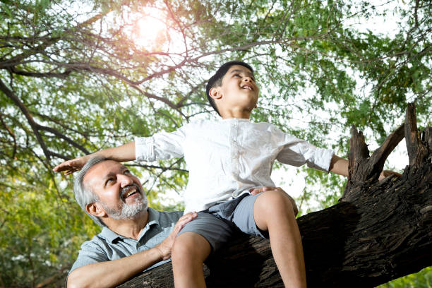istock Old man with grandson admiring nature 1357009003