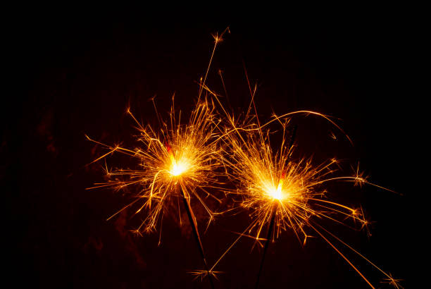 istock Bright burning sparklers on the dark background 1357009829