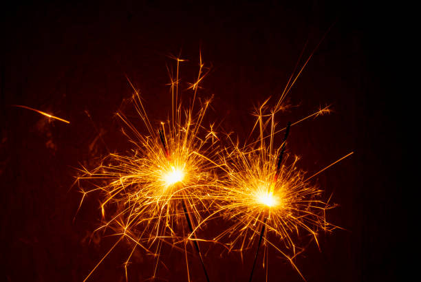 istock Bright burning sparklers on the dark background 1357009831