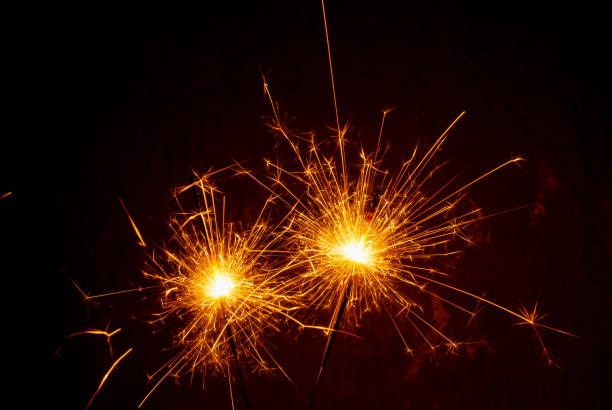 istock Bright burning sparklers on the dark background 1357009834
