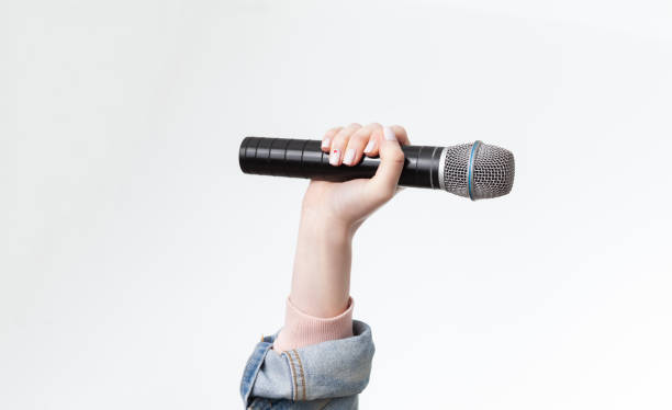 Hand holding microphone stock photo