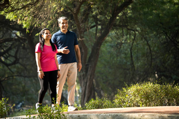 istock Happy couple walking at park 1357011136