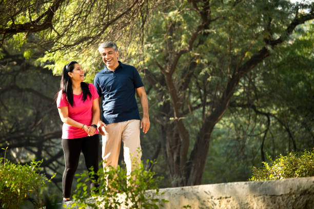 istock Happy couple walking at park 1357011184