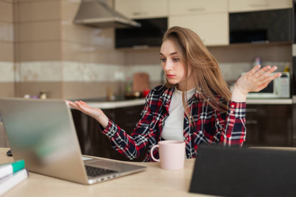 istock Young woman communicates by video call while sitting at the table with laptop 1357011919