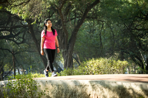 Woman walking at park stock photo