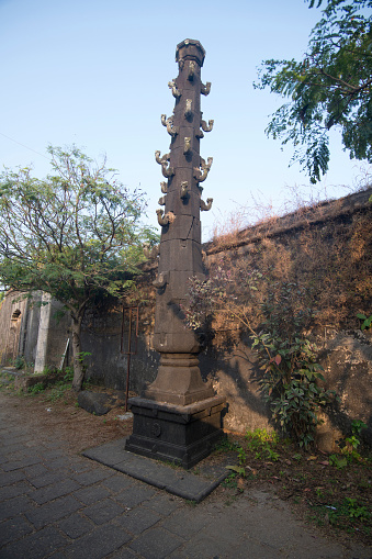 Giant lamp pillar outside the temple gate inside Kolaba fort, Alibaug, Maharashtra, India