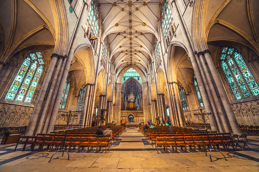 The gothic interior of York Minster Cathedral with natural light in York, North Yorkshire, England.