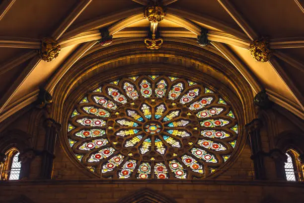 Photo of Medieval stained glass window depicting scenes from the life and martyrdom of Saint Stephen inside cathedral of York Minster in City of York, England, UK