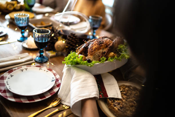 istock Hands serving a roast turkey on Christmas at home 1357014332